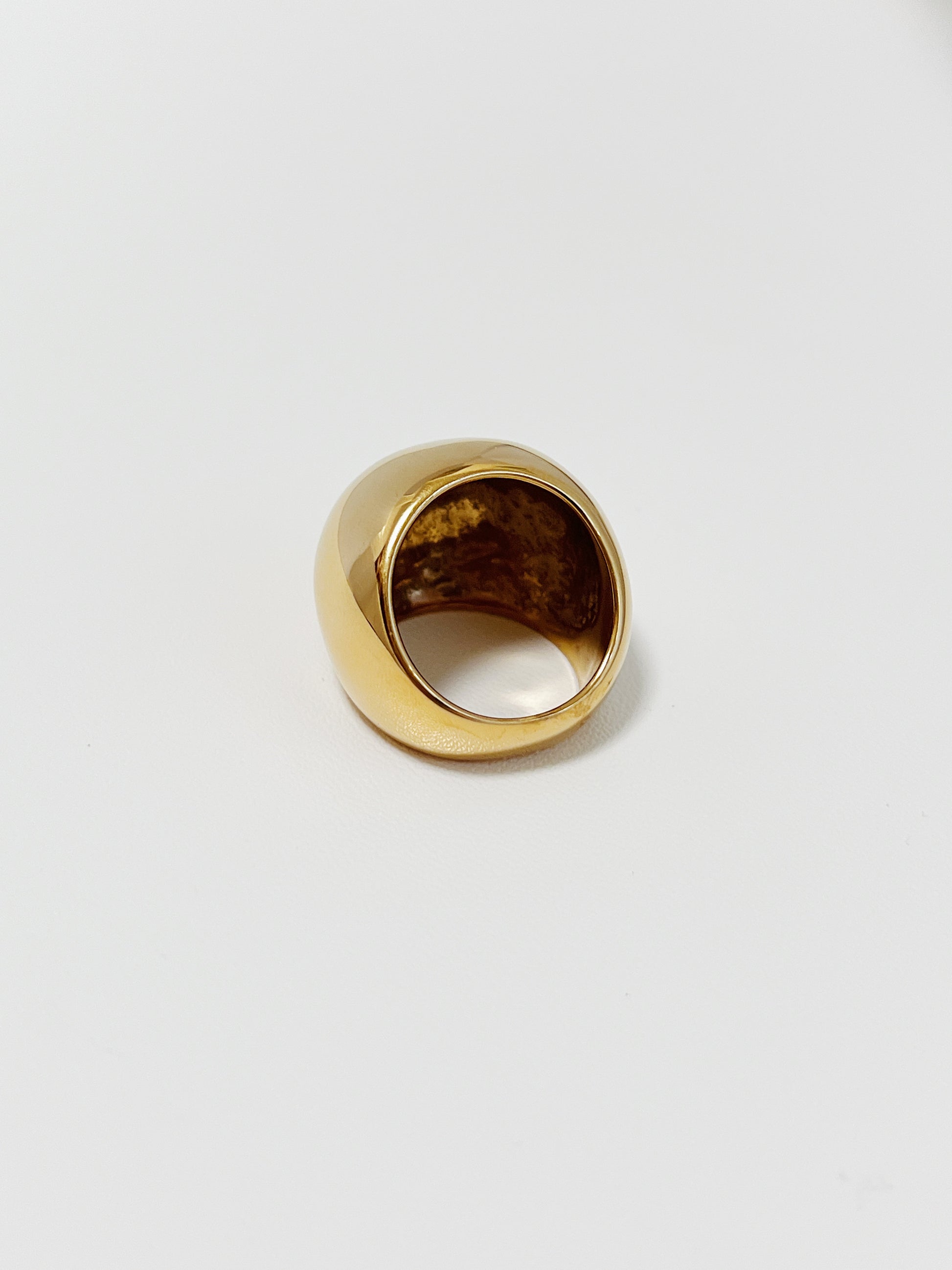 High-polish gold sculptural ring by Aurous Atelier on clean surface
