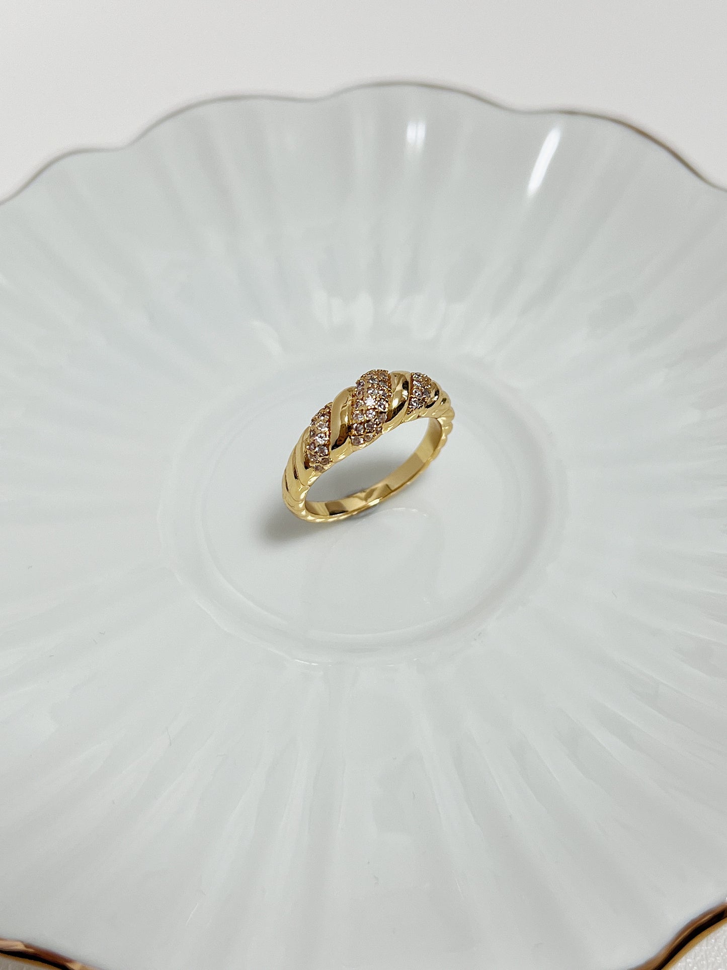 Claudia Pavé Croissant Ring in 18k Gold PVD showing its sparkling gemstone detail on a white ceramic background.
