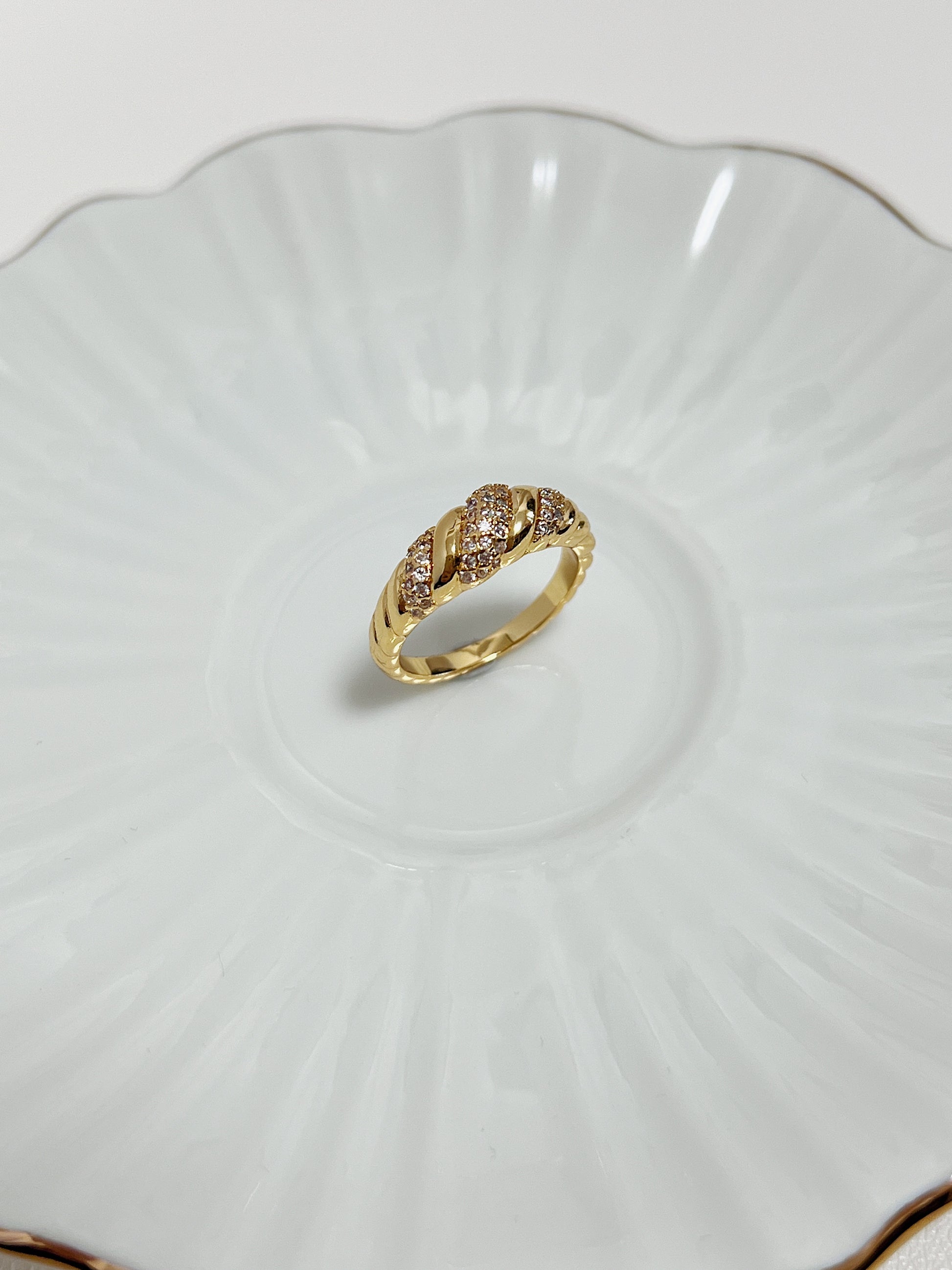 Claudia Pavé Croissant Ring in 18k Gold PVD showing its sparkling gemstone detail on a white ceramic background.