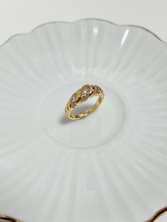 Claudia Pavé Croissant Ring in 18k Gold PVD showing its sparkling gemstone detail on a white ceramic background.