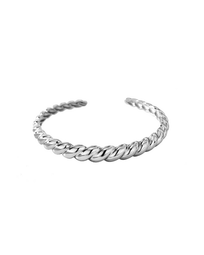 Studio product shot showcasing the Paris Croissant textured open cuff bangle on a clean white background, highlighting its flexible architecture and metallic twisted pattern.