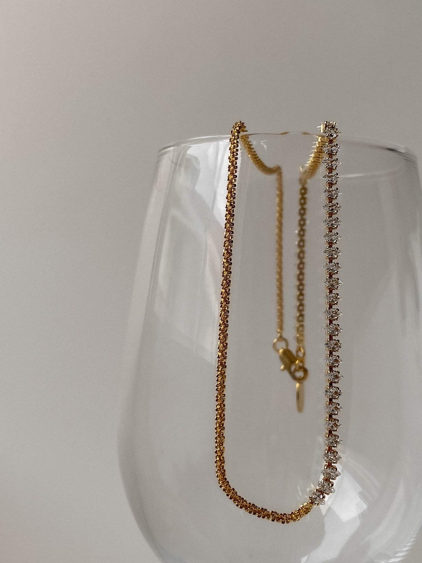 Fine jewelry alternative small batch construction highlighting marquise stone and gold strand