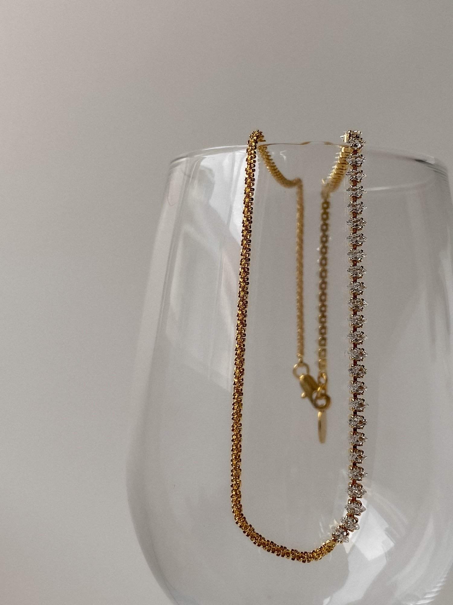Fine jewelry alternative small batch construction highlighting marquise stone and gold strand