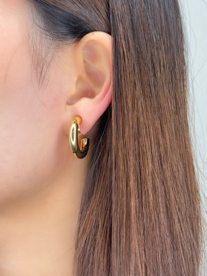 Corporate styling rotation featuring an unpierced collector wearing structural gold hoop jewelry accents