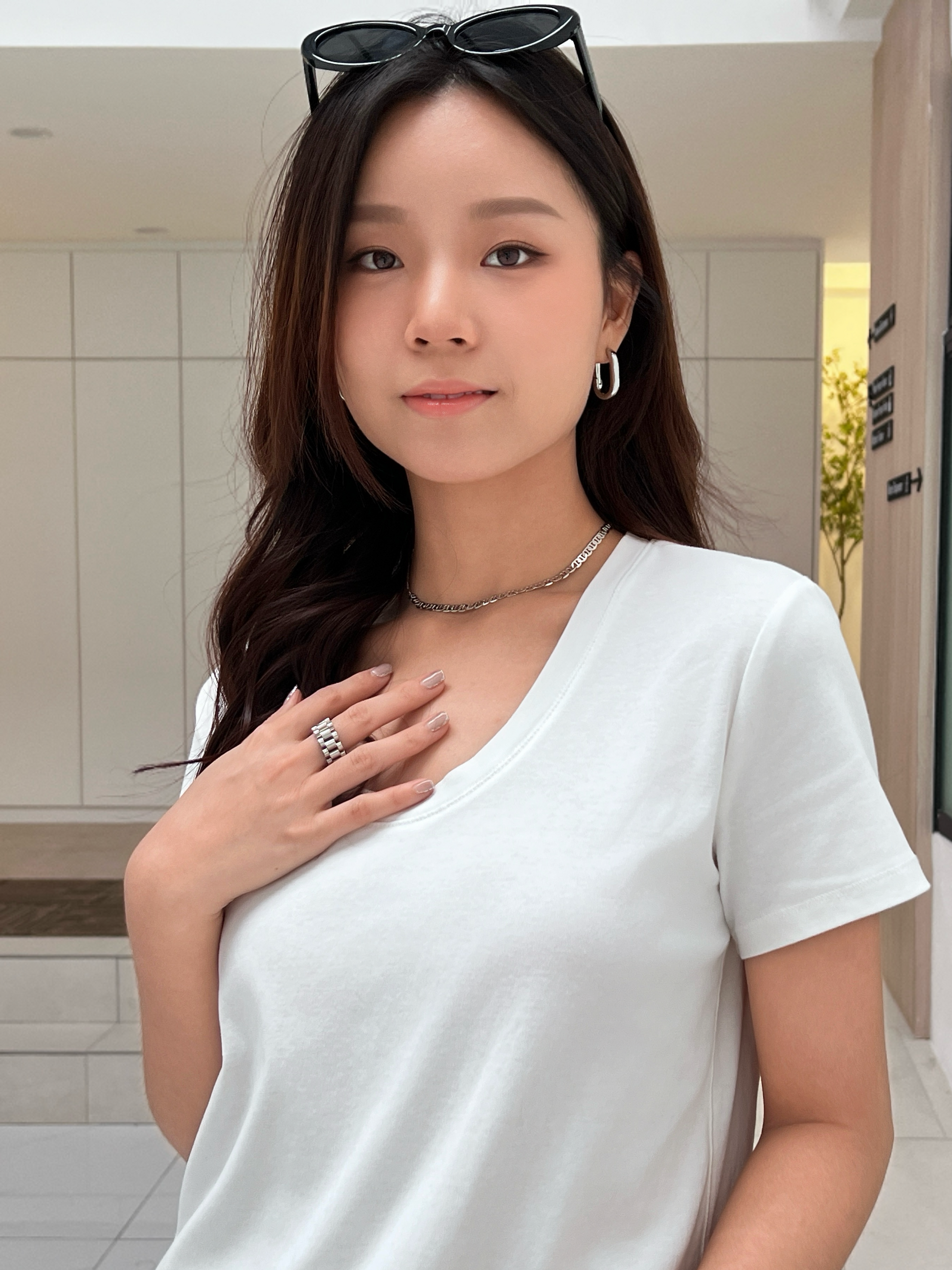 Editorial style crop pairing a silver anchor link chain with an everyday cotton u neck white t-shirt for effortless look