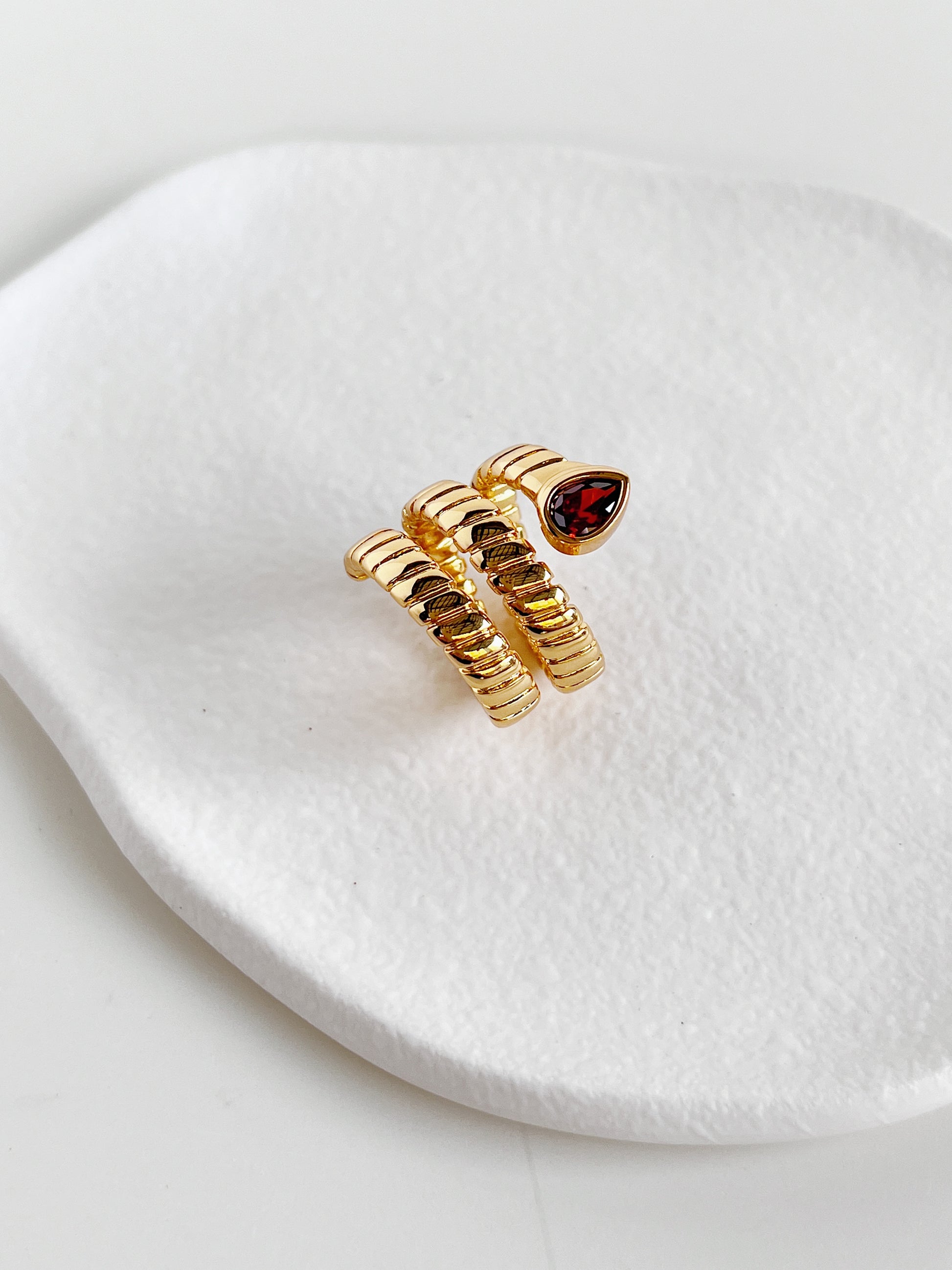 Top view of the coiled snake band ring with a red cubic zirconia stone