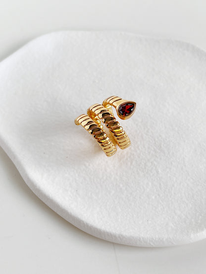 Top view of the coiled snake band ring with a red cubic zirconia stone