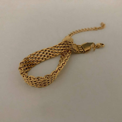 A detailed close-up shot of the gold Danielle mesh chain bracelet loosely looped to highlight the premium flexible structure of the interlocking links.