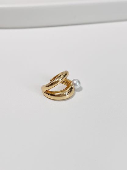 Side view of the Dior Pearl Cuff highlighting the smooth 18K Gold PVD finish and adjustable opening.