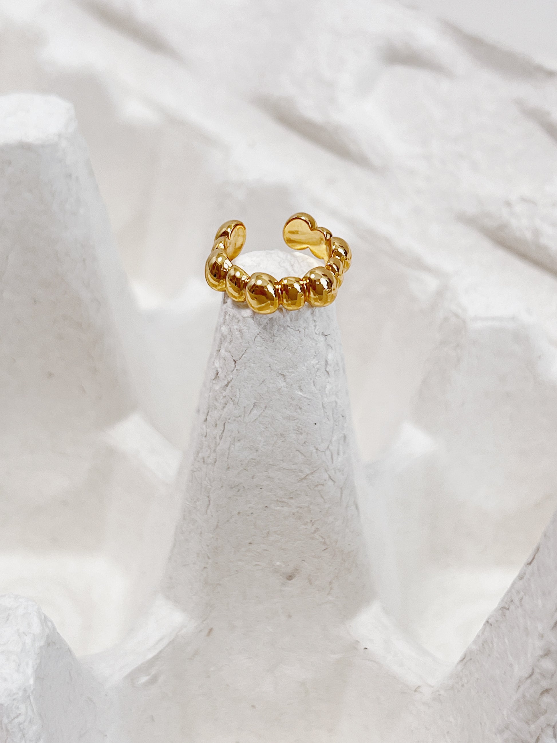 Front-facing view of the Carina cuff on a white surface highlighting the continuous bubble silhouette.