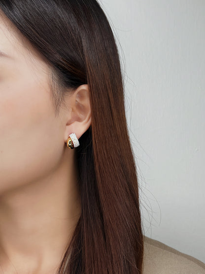 Woman ear edit displaying dimensional look of stacked double hoop illusion studs