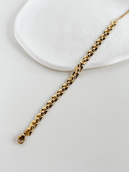 Top view of the gold Evie lightweight watchband chains laid flat on a neutral background to display the slender, uniform width.
