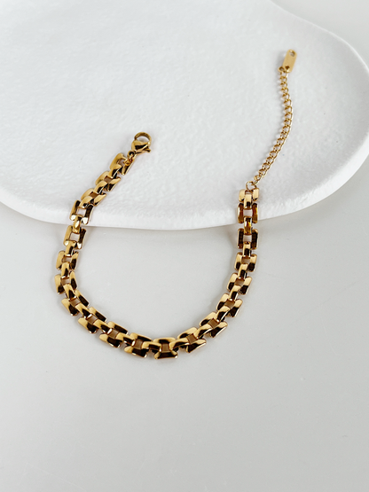 Low-angle product shot showing the thin, low-profile height of the Evie watchband links resting flat.