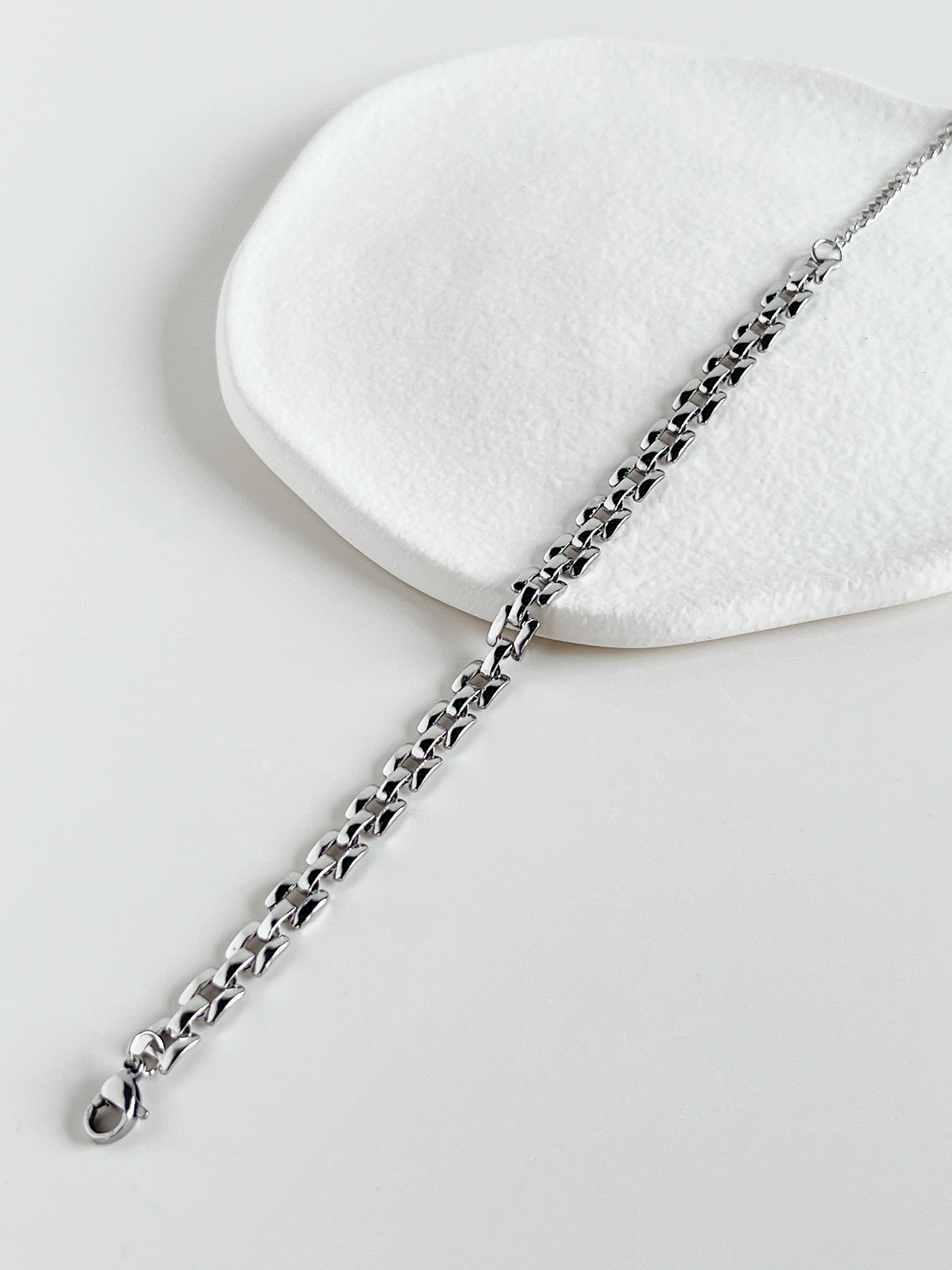 Top view of the Silver Evie lightweight watchband chains laid flat on a neutral background to display the slender, uniform width.