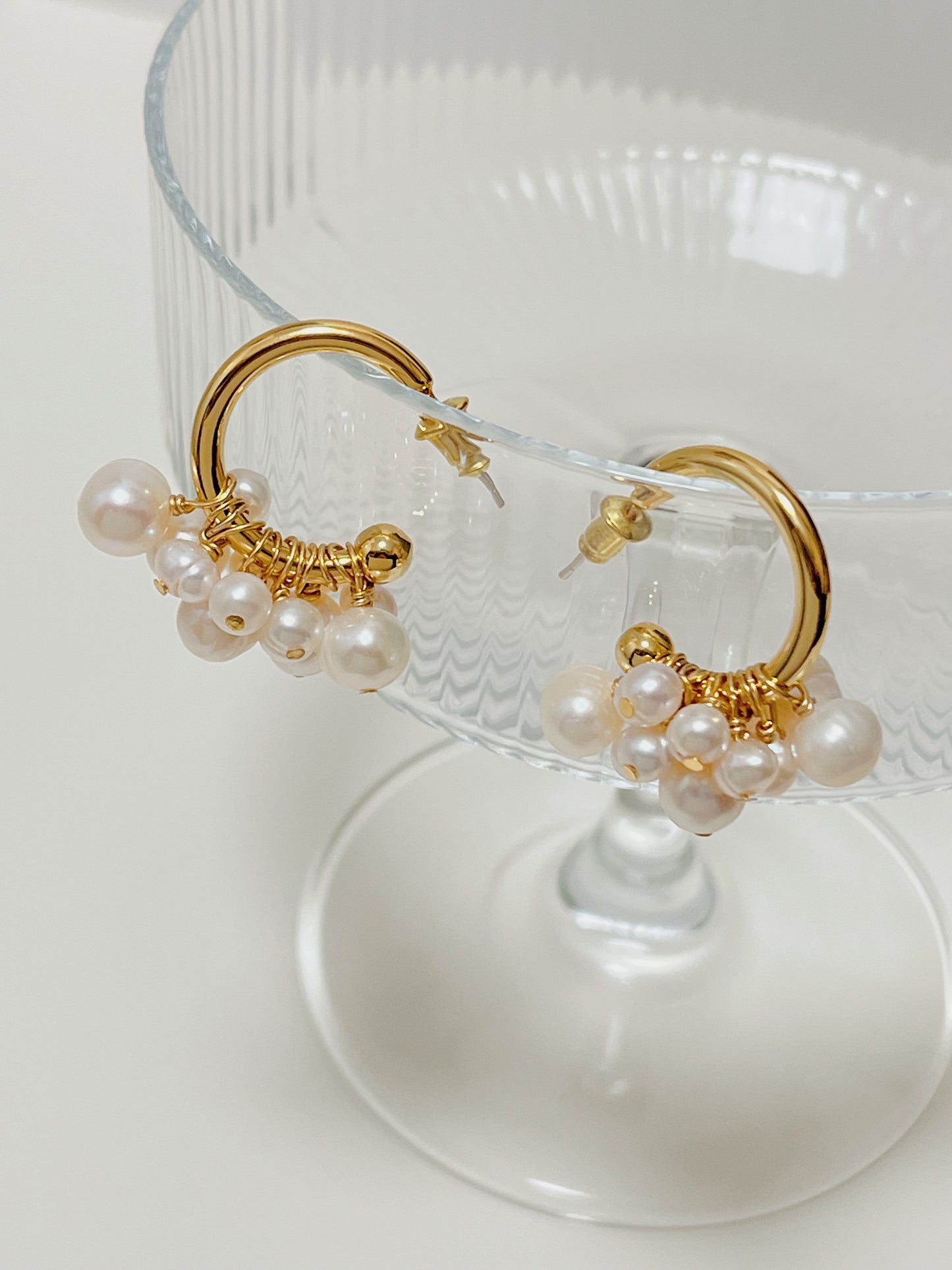 Close structural view of the Freya luxury cluster pearl earrings showing the refined wire wrapping that secures each authentic freshwater gem to the hoop.