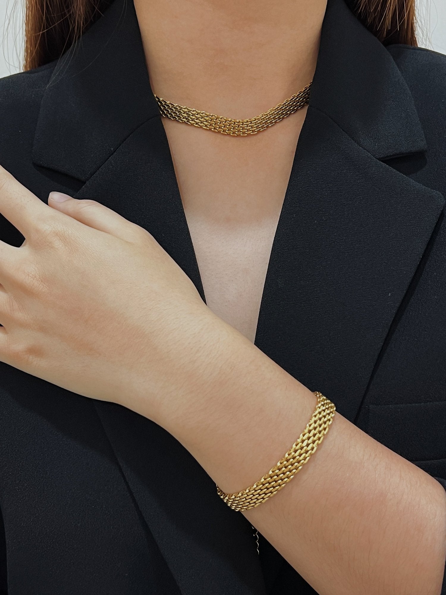 Asymmetric texture look book presentation pairing fluid gold woven metal with rich structural blazer fabrics
