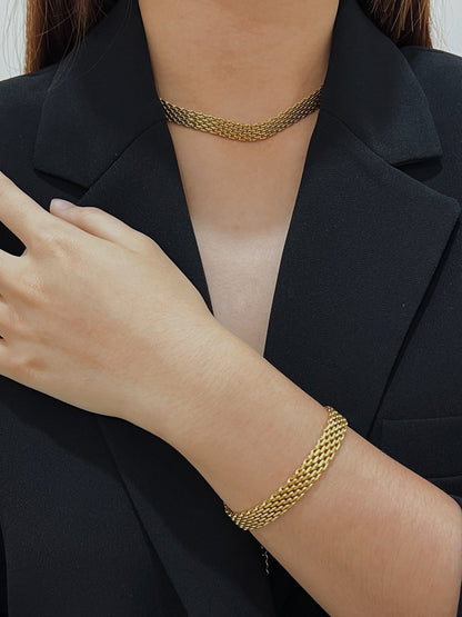 Asymmetric texture look book presentation pairing fluid gold woven metal with rich structural blazer fabrics