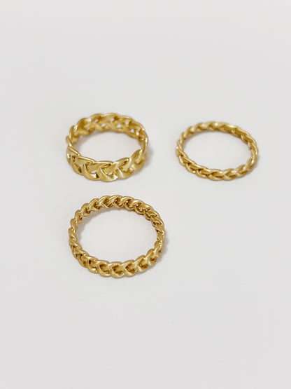 Irene brushed gold braided rings on a minimalist white background.