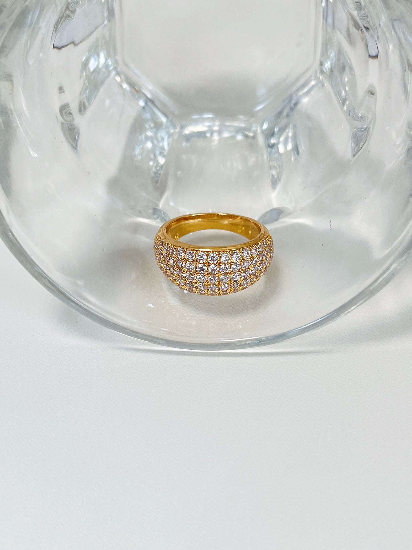 Close up of precision set cubic zirconia on gold eternity band