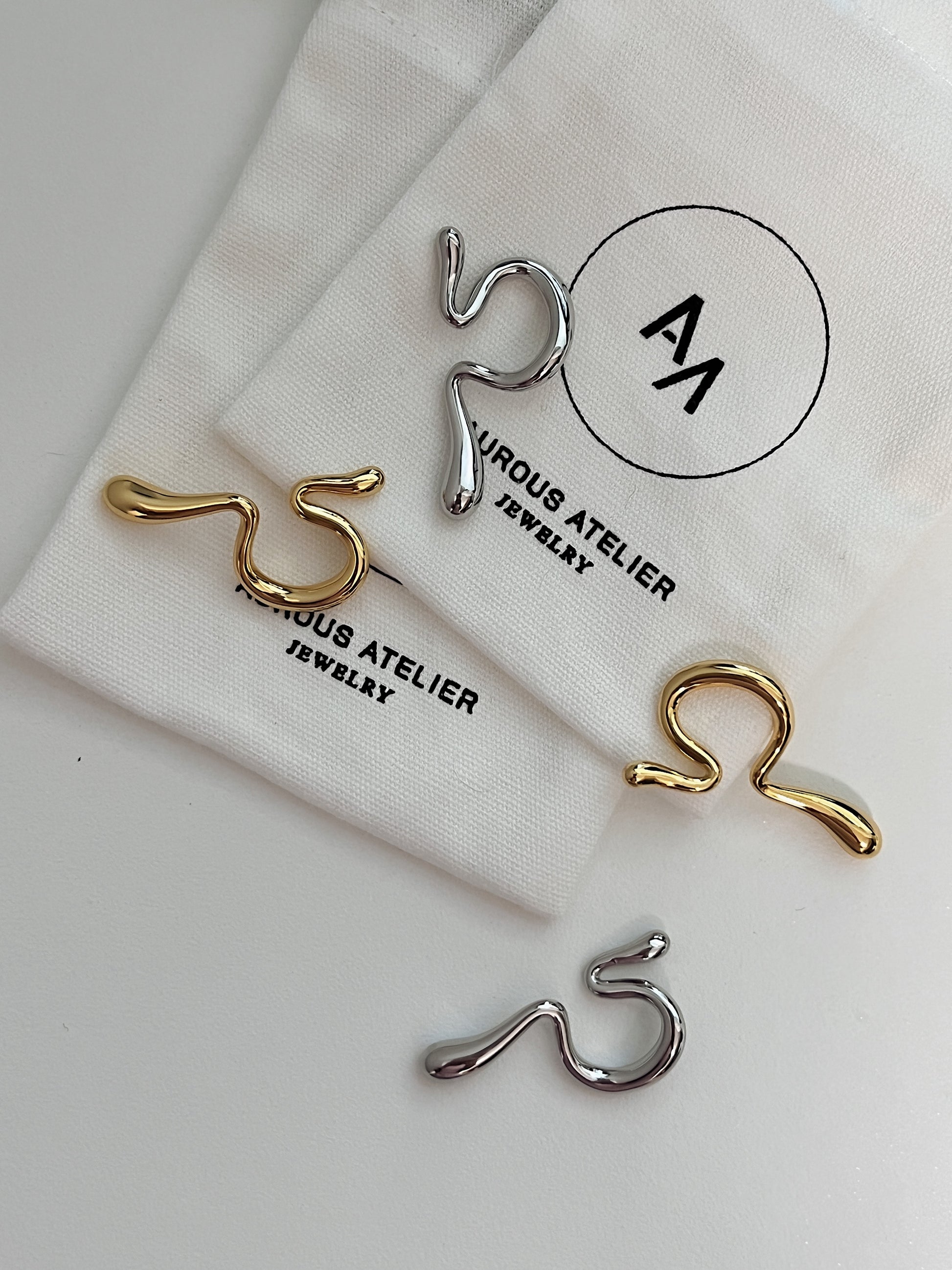 Detail of the gym safe waterproof Tia gold and silver abstract ear cuff.