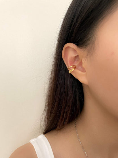 Side profile of a model featuring a curated stack with waterproof gold jewelry