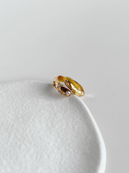Close up of organic hammered texture on gold asymmetrical statement ring