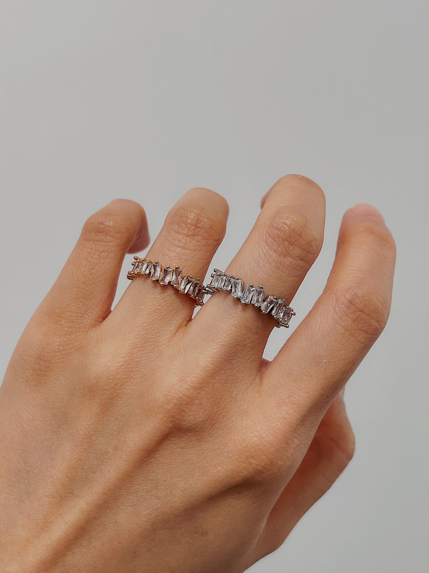 Hand stack featuring the Lizza eternity band in gold and silver tones