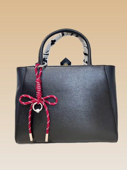 High density crimson and white patterned utility rope accessory showing polished metallic column aglet tips
