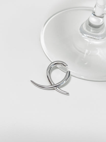Close-up of silver Harley Geometric Ear Cuff showing the S925 hallmark and sharp "X" design.