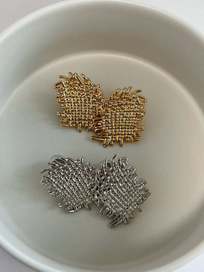 Side-by-side view comparing 18K gold plated and rhodium plated Hazel textured earrings