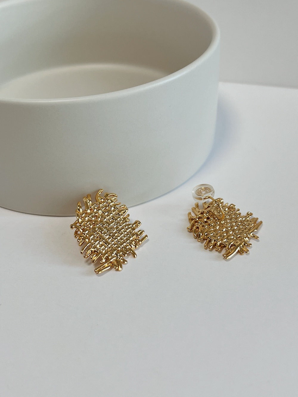 Flatlay showing 31mm x 25mm dimensions of Hazel textured statement earrings on white surface