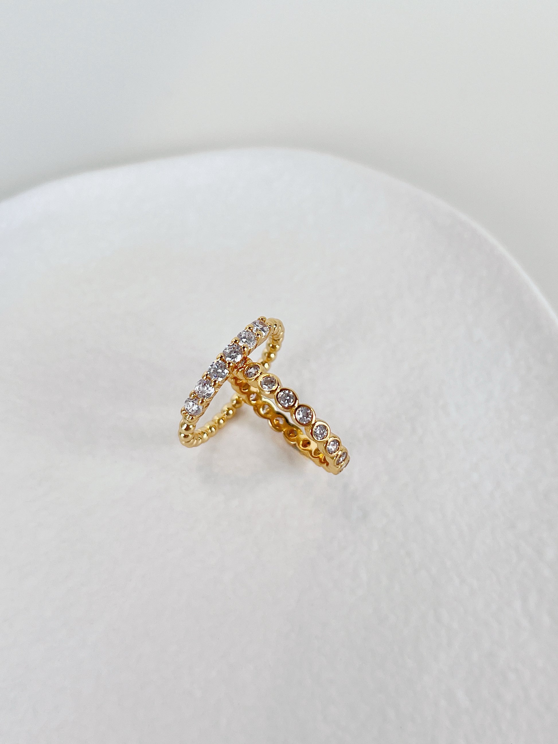 Close up of 18k gold pvd brass core eternity ring showing continuous stones