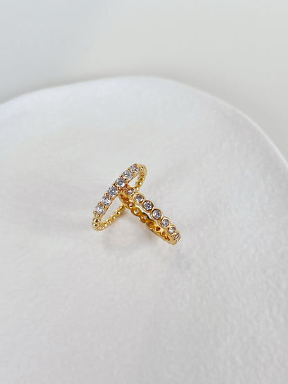 Close up of 18k gold pvd brass core eternity ring showing continuous stones