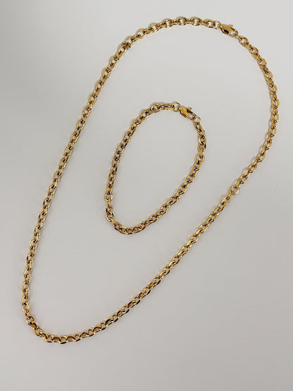Premium demi fine jewelry catalog display focusing on the structural core alignment of a gold chain necklace and bracelet