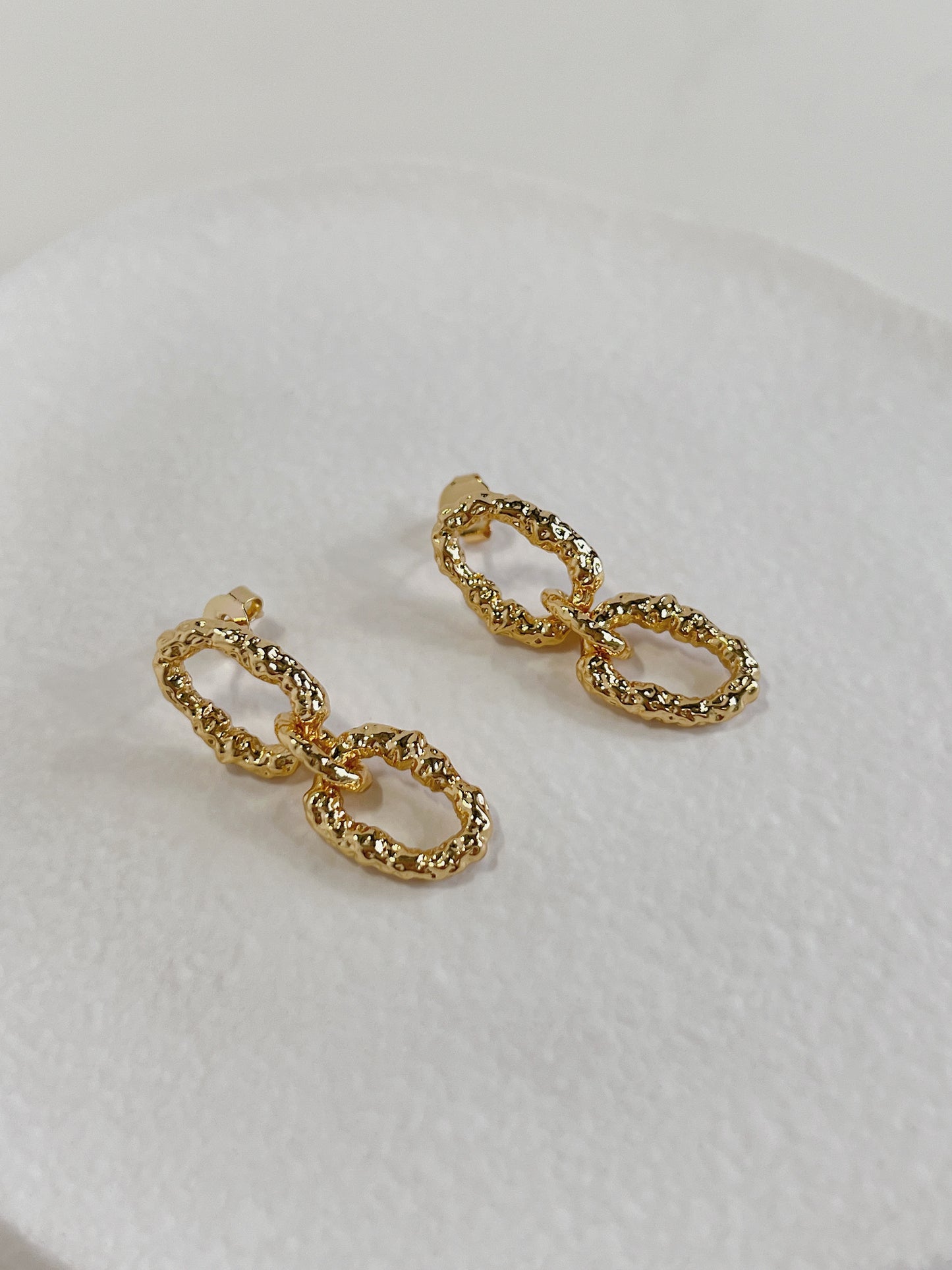 High refraction statement earrings with irregular cratered facets built for modern lookbook styling curation
