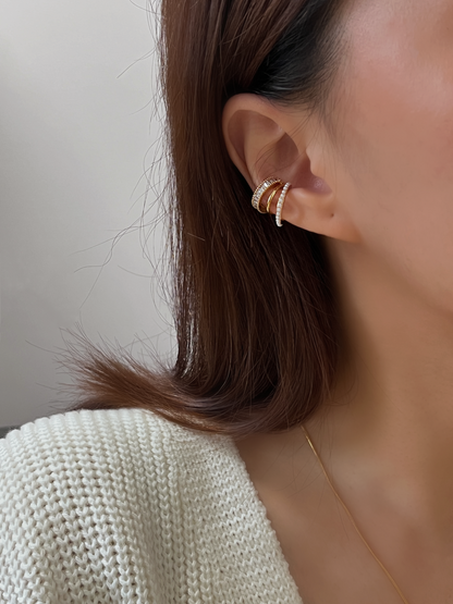 Profile shot of model with a curated ear stack featuring the Luxe cuff.