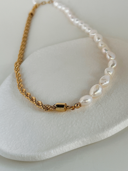 Organic high luster baroque pearls hand strung on a contemporary mixed media necklace