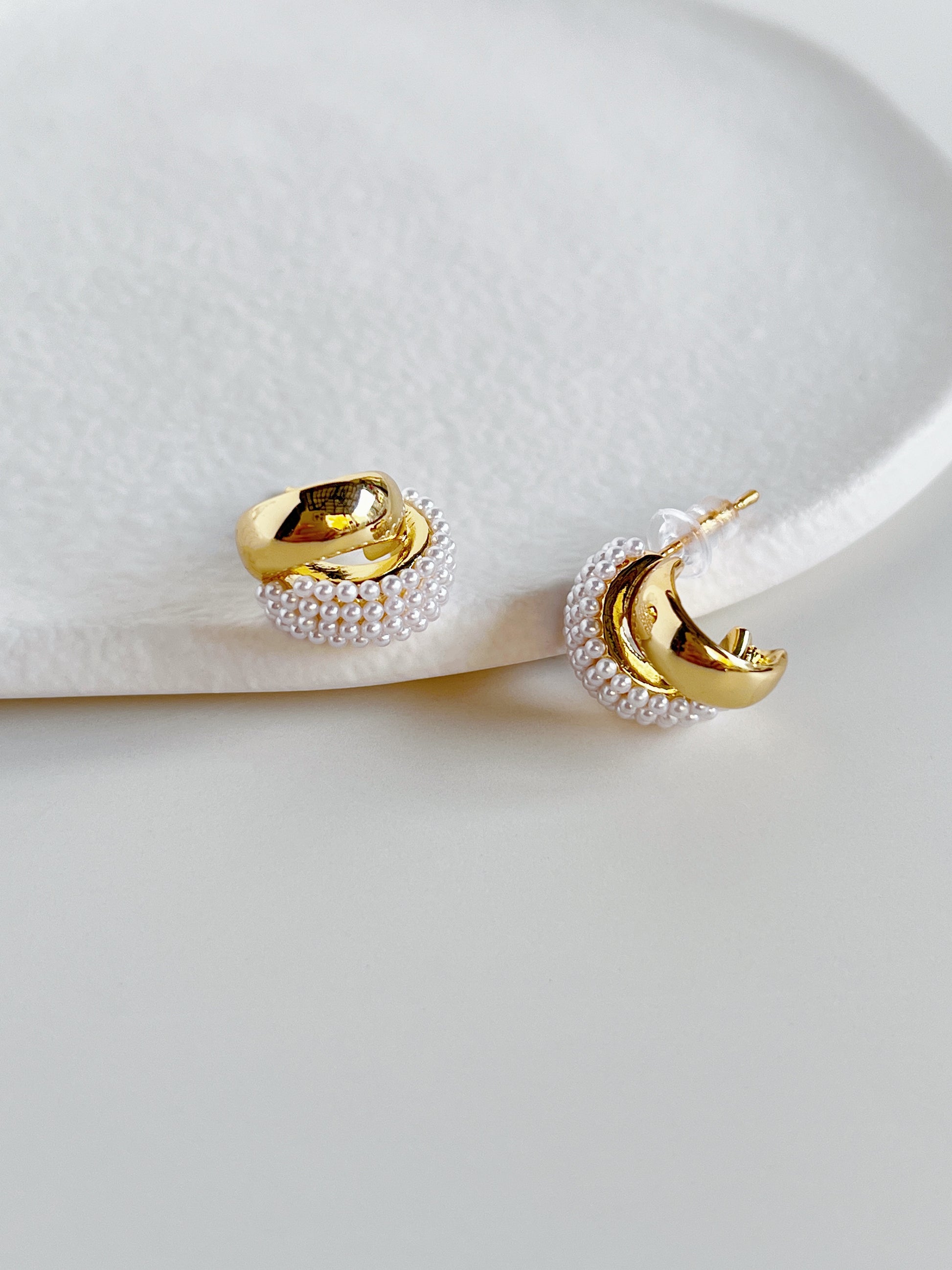 High polish yellow gold earring posts featuring comfortable secure plastic clutch backings