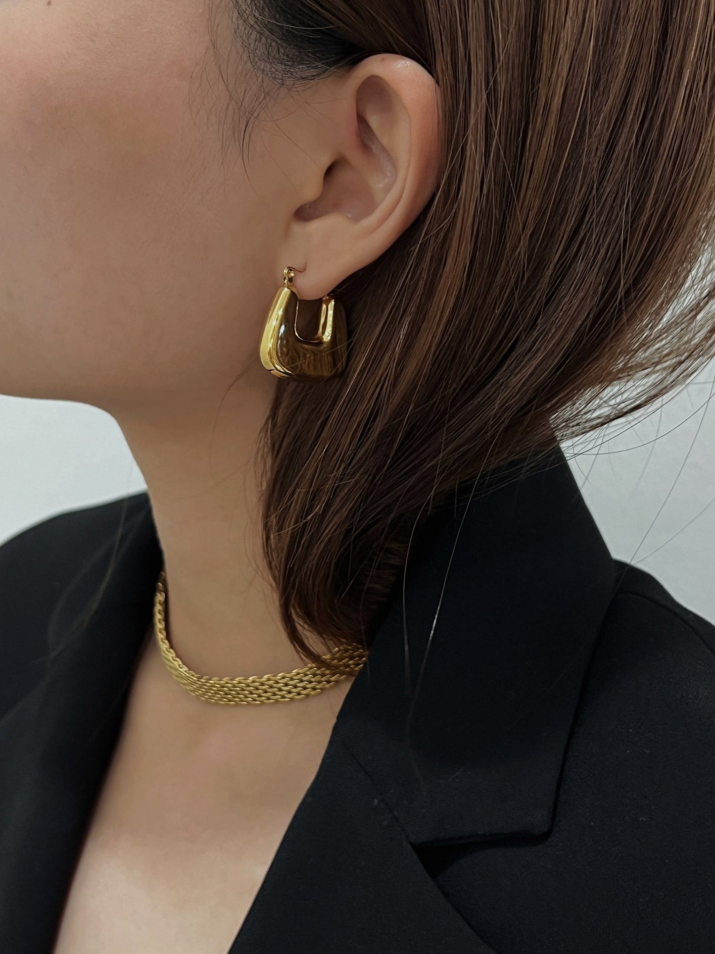 Aurous atelier modern luxe presentation showcasing a woman personalizing her minimal tailored jewelry capsule