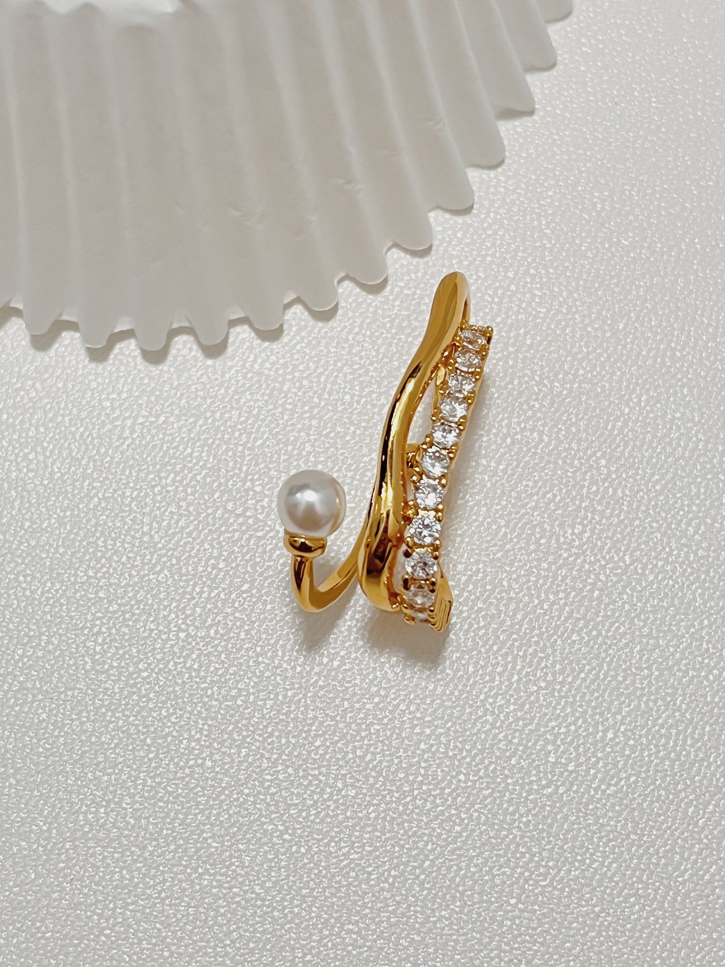 Intricate front view of the delicate Cassidy Pearl and Crystal Gold Cuff Earring, illustrating its comfortable, non-pierced design and glamorous multi-layered aesthetic.