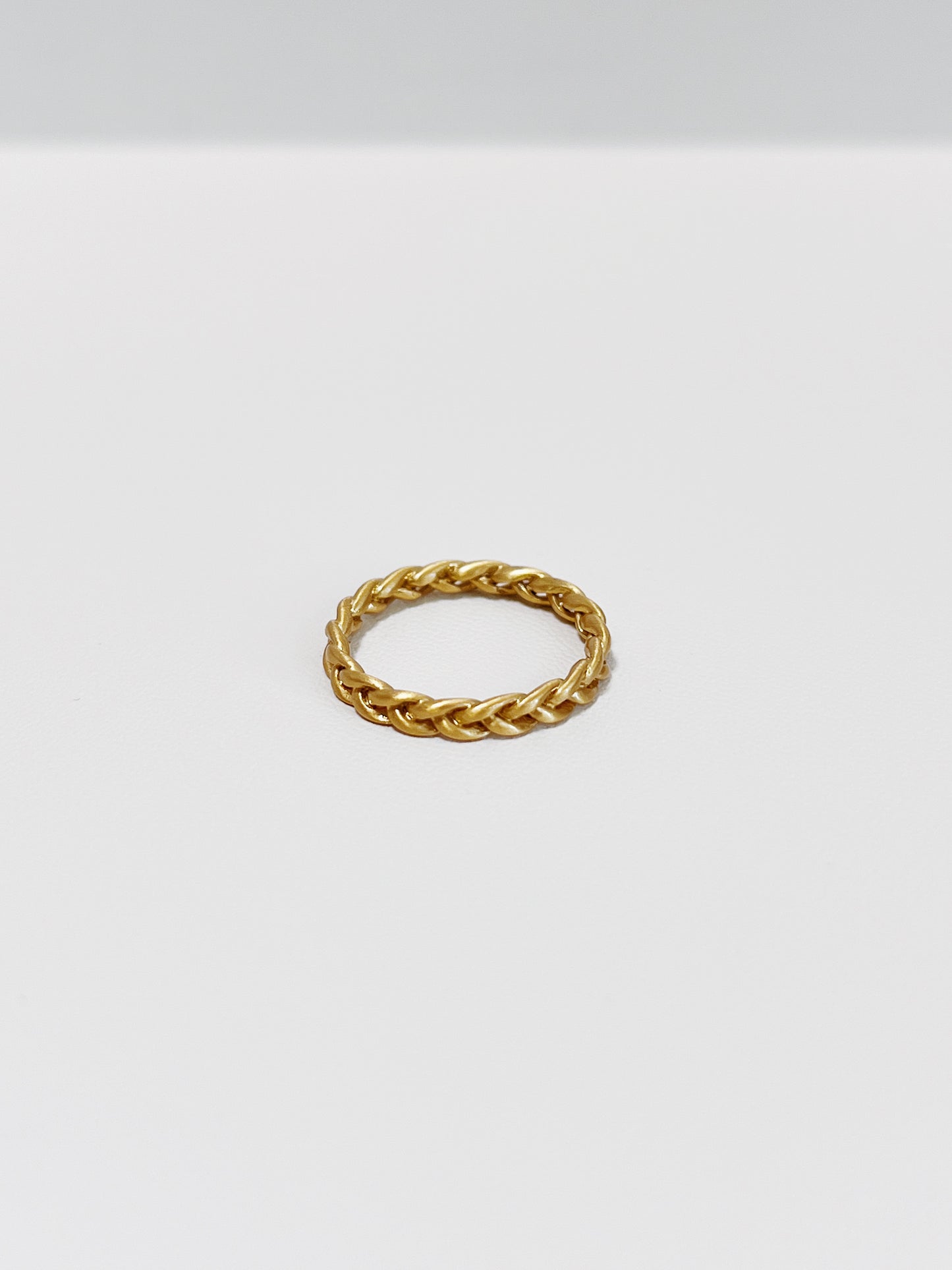 Close-up of Irene Gold braided ring in 3mm on a white background