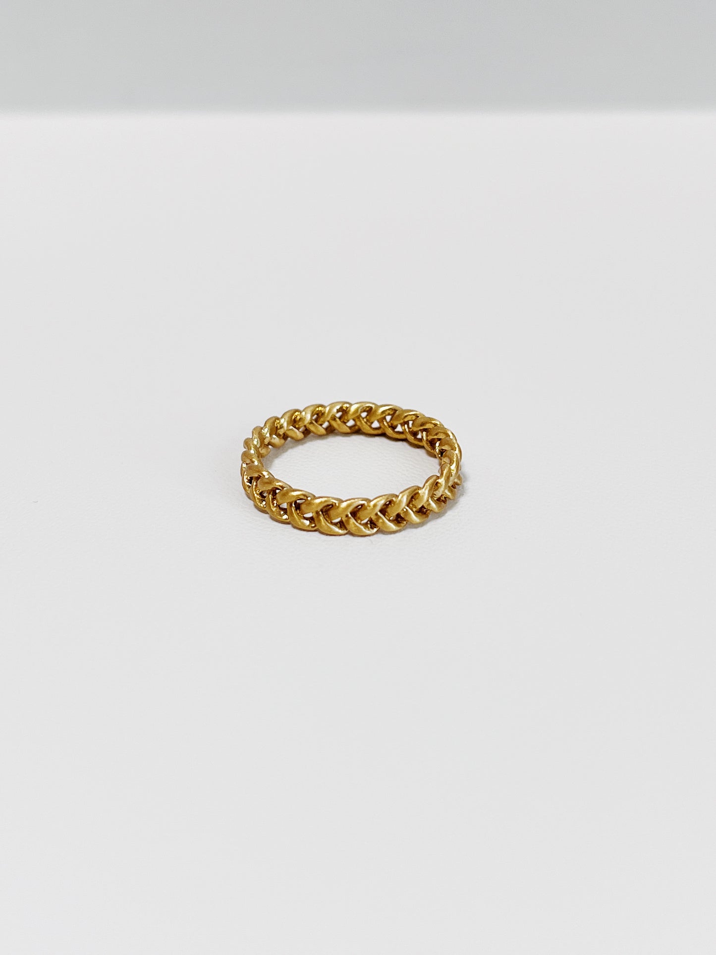 Close-up of Irene Gold braided ring in 4mm on a white background