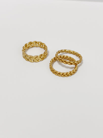 Side-by-side view of matte 18k gold PVD Irene twisted rings in different width.