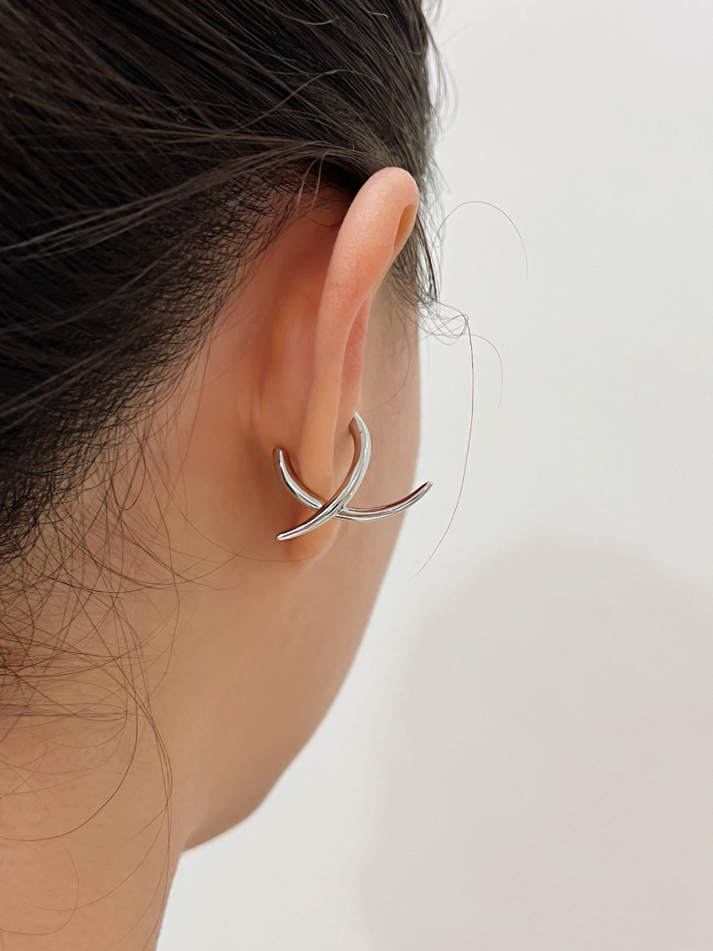 Back view of model wearing the Harley cuff to show how the "X" shape contours the ear.