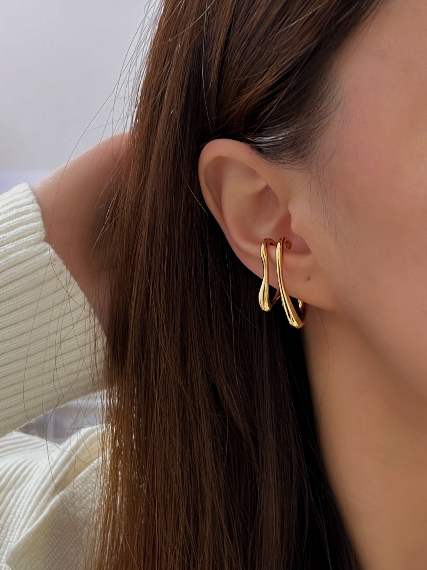 Model showcasing the high-shine molten gold finish in natural sunlight.