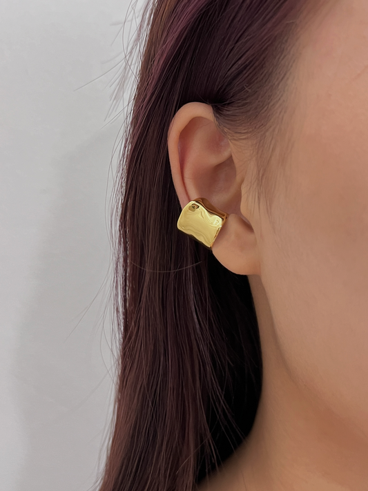 Model wearing Kelly wide gold ear cuff on mid-cartilage.