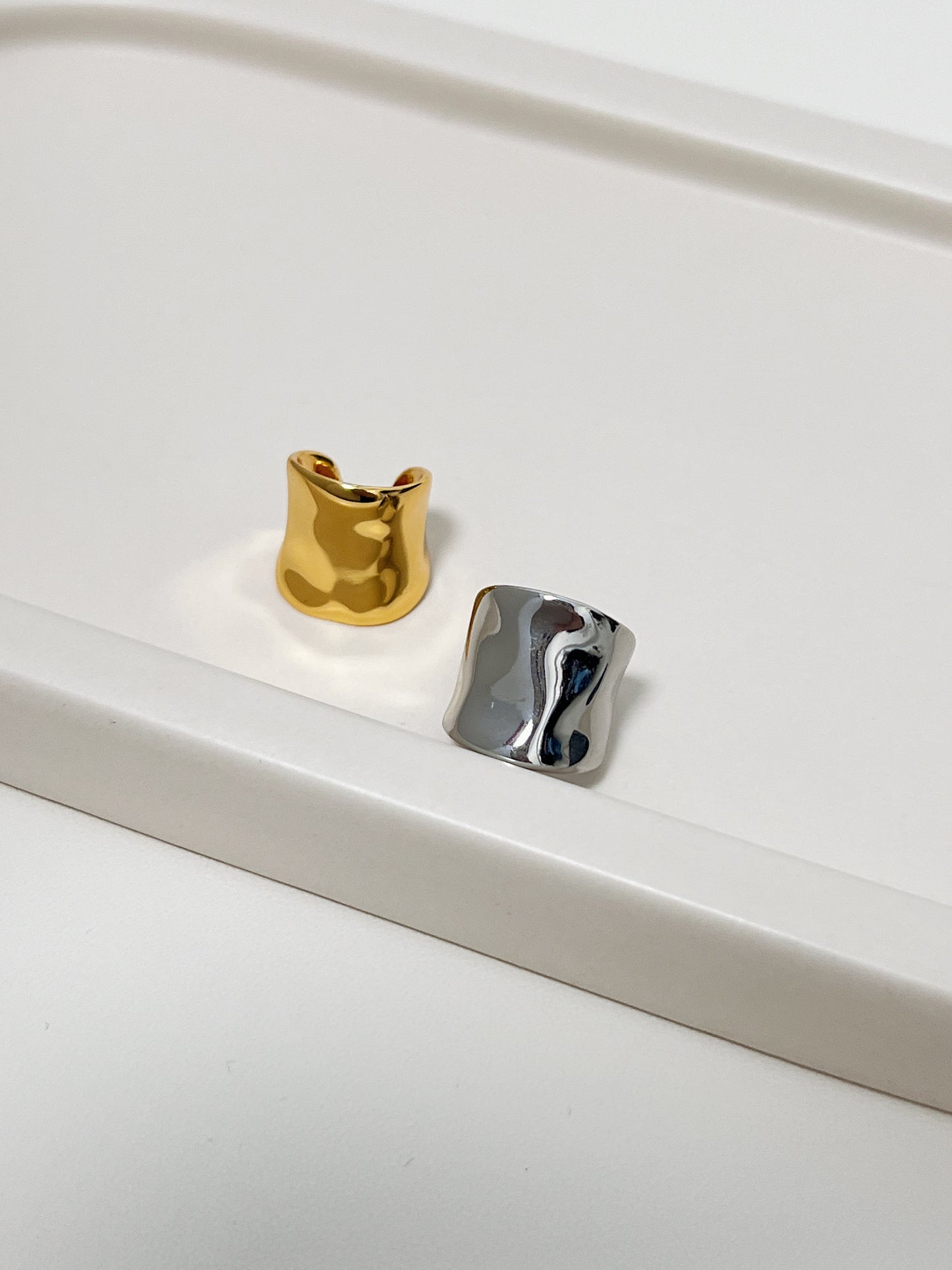 Top-down view of Kelly wide-band gold ear cuff.