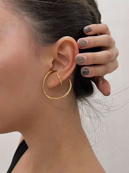 Model with a slicked-back bun highlighting the Kendra architectural cuff.