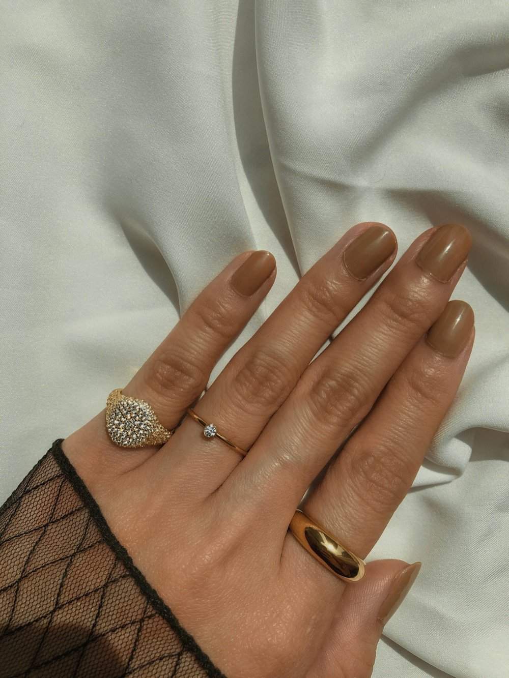 Hand stack featuring Andrée gold signet and delicate gold bands.