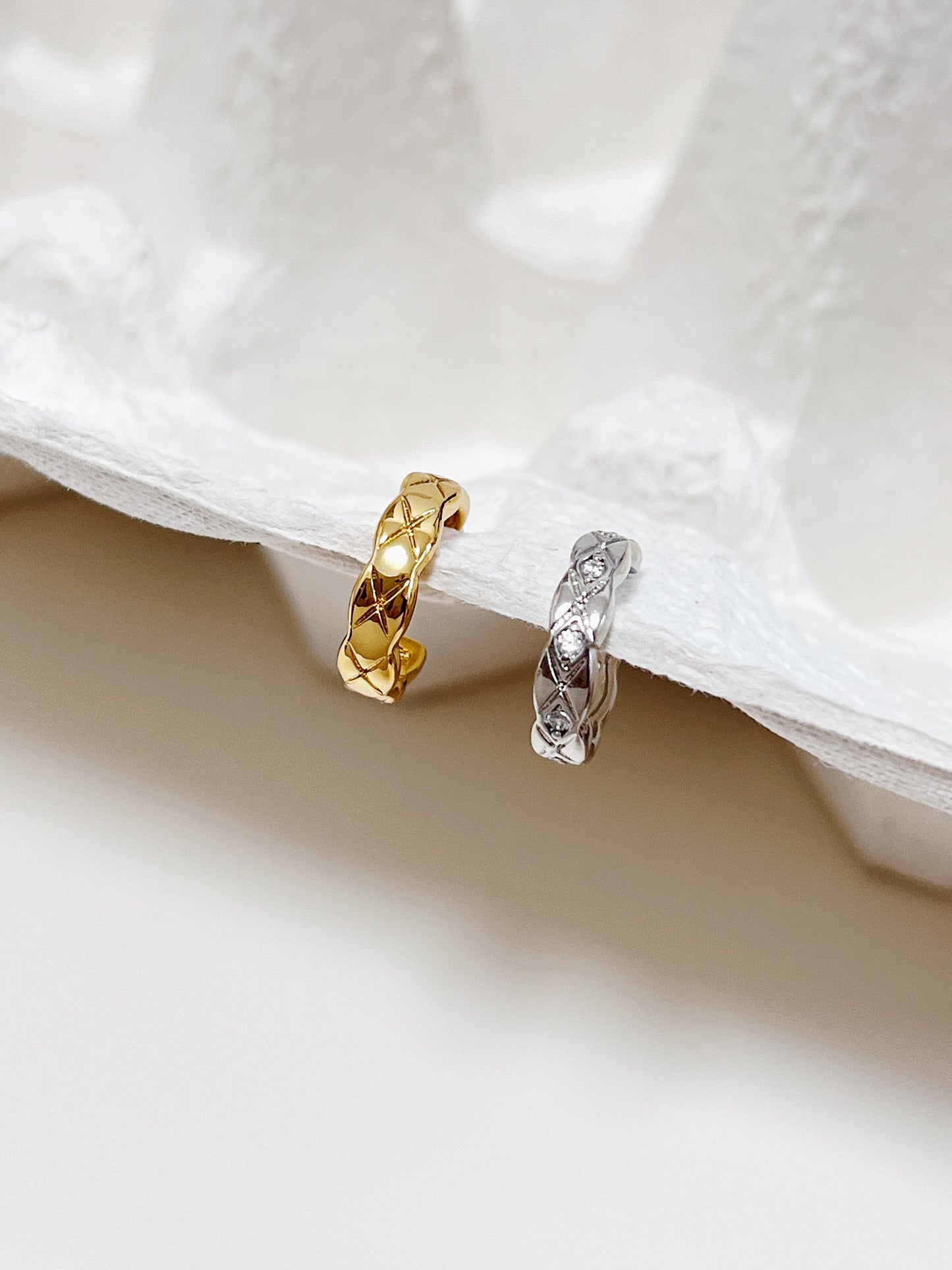 Close-up of gold Louie Quilted Ear Cuff showing deep-etched diamond texture.